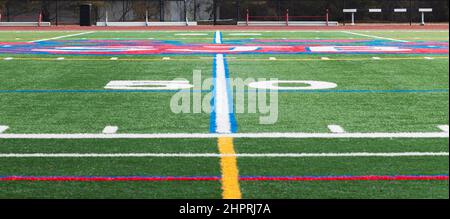 Blick auf die 50-Meter-Linie auf einem Sportrasenfeld der High School. Stockfoto