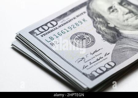 Ein Paket von hundert Dollar liegt auf weißem Hintergrund, die US-Währung USD Nahaufnahme Foto mit selektivem Fokus auf das Federal Reserve System Stockfoto