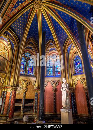 Statue von Saint Louis in Sainte Chapelle: Extravagante, mit Gold vergoldete Bögen in einer tiefblauen Decke Rahmen eine Statue von Saint Louis IX an der Vorderseite des unteren Stockes der berühmten Kapelle. Stockfoto