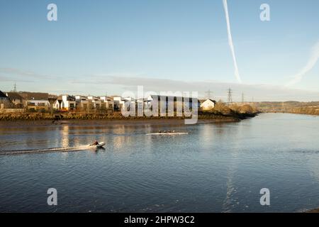 Blaydon auf Tyne Großbritannien: 30th. Januar 2022: Ruderer auf dem Fluss Tyne an einem frühen sonntagmorgen. Rudern Wassersport Übung. Chemtrails am Himmel Stockfoto