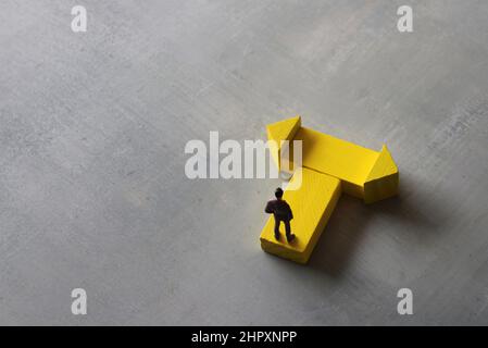 Entscheidungskonzept. Miniatur-Mann steht an einem Wendepunkt. Platz für Text kopieren. Stockfoto