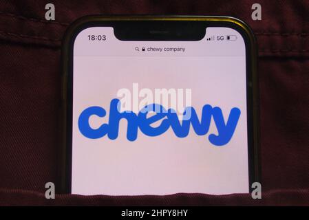 KONSKIE, POLEN - 22. Februar 2022: Das Chewy Inc-Logo wird auf dem Mobiltelefon in der Jeans-Tasche versteckt angezeigt Stockfoto