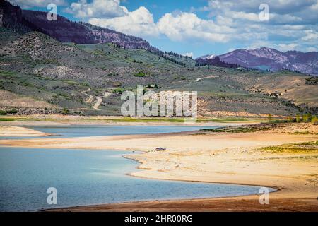 Fast ausgetrocknet Blue Mesa Reservoir in der Nähe von Gunnison Colorado USA mit Pickup in der Nähe von Wasser geparkt und jemand schwimmt Stockfoto