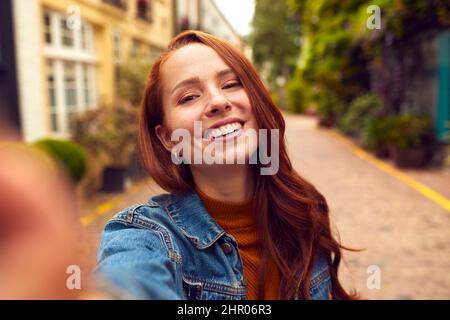 Blickwinkel Aufnahme Einer Jungen Frau, Die Den Mann Durch Die City Street Führt Stockfoto