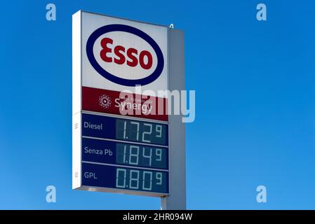 Fossano, Italien - 22. Februar 2022: Esso-Logo mit Kraftstoffpreisanzeige am blauen Himmel, Esso ist eine Marke des globalen Ölindustriegiganten ExxonMob Stockfoto