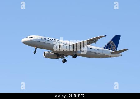 SeaTac, WA, USA - 23. Februar 2022; United Airlines Airbus A320 200 über den endgültigen Landeanflug gegen einen klaren blauen Himmel Stockfoto