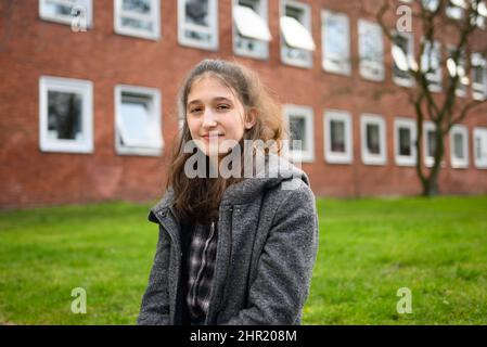 Hannover, Deutschland. 24.. Februar 2022. Greta Harling, Schülerin der Klasse 11. an der Schiller High School, sitzt außerhalb ihrer Schule. Die Corona-Pandemie ist auch für Studenten sehr stressig. (Zum dpa-Themenpaket zu zwei Jahren Corona-Pandemie in Niedersachsen) Quelle: Julian Stratenschulte/dpa/Alamy Live News Stockfoto