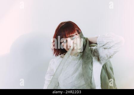 Verspielte kaukasische junge Erwachsene Rotschopf Frau Spaß im Studio einen sonnigen Tag Stockfoto