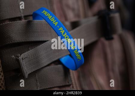 Gelb-blaues Armband mit einer Inschrift auf Ukrainisch: 'Ukraine - gemeinsam für den Frieden!' Verhinderung von Feindseligkeiten in der Ukraine. Friedenskonzept Stockfoto