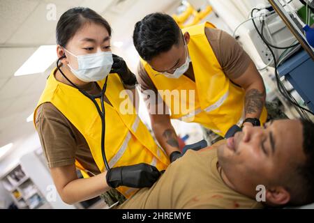 Camp Lemonnier, Dschibuti. 26. Januar 2022. Lucy Shi, LT. Der US-Marine, Flugchirurgen der Michaud Expeditionary Medical Facility, verwendet ein Stethoskop, um die Herzfrequenz eines simulierten Patienten während einer Massenübung mit Verletzten auf Basis zu überprüfen. CLDJ dient als Expeditionsbasis für US-Streitkräfte, die Schiffe, Flugzeuge und Personal unterstützen, die die Sicherheit in ganz Europa, Afrika und Südwestasien gewährleisten. Die Basis ermöglicht See- und Kampfeinsätze am Horn von Afrika und fördert gleichzeitig positive Beziehungen zwischen den USA und Afrika. (Bild: © U.S. Navy/ZUMA Press Wire Service/Zhumapress.Co Stockfoto