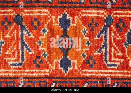 Rot orange und blau Orientalischer Teppich Detail Hintergrundbild Stockfoto