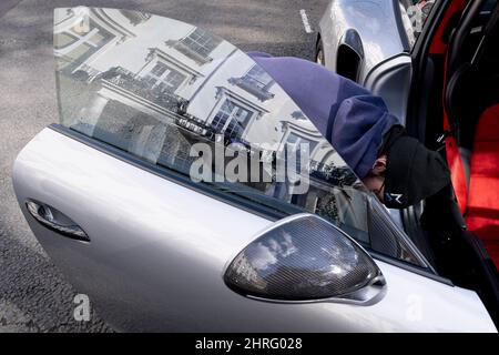 Ein Autowaschmann reinigt einen luxuriösen Porsche auf dem Chester Square in London SW1, wo eine Reihe russischer Immobilienbesitzer - darunter Roman Abramovich - investiert haben sollen - und nach der russischen Invasion der Ukraine, jetzt am zweiten Tag, Am 25.. Februar 2022 wurden in London, England, weitere Sanktionen gegen russische Handelsinteressen im Vereinigten Königreich angekündigt. Die Kampagnengruppe „Transparency International“ sagt, dass geschätzte 1,5bn £von britischen Immobilien über die City of London, den Finanzbezirk der britischen Hauptstadt, mit verdächtigen Mitteln aus Russland ausgegeben wurden. (Foto von Richard Baker / in Bildern via Ge Stockfoto