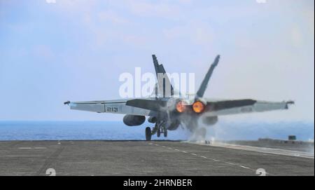 PHILIPPINISCHES MEER (Feb 24, 2022) Konteradmiral J.T. Anderson, Commander, Carrier Strike Group 3, startet in einer F/A-18E Super Hornet, die den 'Tophattern' von Strike Fighter Squadron (VFA) 14 zugewiesen wurde, vom Flugdeck des Nimitz-Klasse-Flugzeugträgers USS Abraham Lincoln (CVN 72) aus. Die Abraham Lincoln Strike Group befindet sich im geplanten Einsatzgebiet der US-Flotte für 7., um die Interoperabilität durch Allianzen und Partnerschaften zu verbessern und gleichzeitig als reaktionsfähige Truppe zur Unterstützung einer freien und offenen Region im Indo-Pazifik-Raum zu dienen. (USA Navy Foto von Mass Communication Specialist 3. Clas Stockfoto