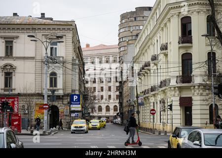 Bukarest, Rumänien - 23. Februar 2022: Alte Häuser mit schöner Architektur in der Academiei Street. Auf der linken Seite ist das ehemalige Haus der Oppler Brauerei, Stockfoto