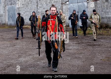 Non Exclusive: SIURTE, UKRAINE - 19. FEBRUAR 2022 - Ein Mann trägt Gewehre während einer militärischen Übung für Zivilisten, die von der Bewegung der Veteranen durchgeführt wurde Stockfoto