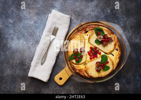 Heißer Quark-Auflauf oder Pudding mit Croutons und frischen Beeren in einer Glasbackform, gesundes Essen, Dessert Stockfoto