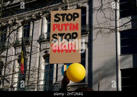 Brüssel, Belgien. 26.. Februar 2022. Demonstranten halten während einer Demonstration gegen die russische Invasion in der Ukraine am 26. Februar 2022 bei der Ständigen Vertretung der Russischen Föderation in Brüssel, Belgien, Schilder und Flaggen auf. Kredit: ALEXANDROS MICHAILIDIS/Alamy Live Nachrichten Stockfoto