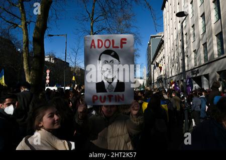 Brüssel, Belgien. 26.. Februar 2022. Demonstranten halten während einer Demonstration gegen die russische Invasion in der Ukraine am 26. Februar 2022 bei der Ständigen Vertretung der Russischen Föderation in Brüssel, Belgien, Schilder und Flaggen auf. Kredit: ALEXANDROS MICHAILIDIS/Alamy Live Nachrichten Stockfoto