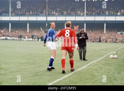 Das 1966 FA Charity Shield Merseyside Derby-Spiel zwischen Liverpool und Everton im Goodison Park. Vor dem Spiel haben Roger Hunt, Alan Ball und Ray Wilson die Weltmeisterschaft, den FA Cup und die Football League Trophy um den Goodison Park geführt. Liverpool gewann das Spiel mit einem Tor von 1 zu 0. Das Bild zeigt: Roger Hunt und Ray Wilson, Mitglieder des siegreichen England-Teams des Sommers, paradieren die WM-Trophäe um das Stadion. 13.. August 1966. Stockfoto