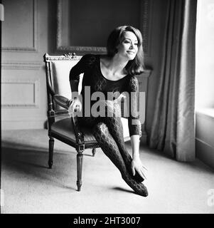 Die Parisienne-Schauspielerin Claudine Auger, die Domino im James Bond-Film Thunderball spielen wird, der hier während eines Interviews mit dem Daily Mirror-Showbusiness-Reporter Donald Zec zu sehen ist. 17.. Februar 1965 Stockfoto