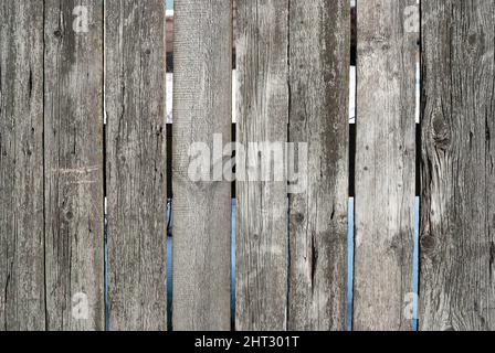 Der Hintergrund besteht aus alten Holzbrettern (Holzbalken). Vintage-Textur, Hintergrund. Verblasste graue Farbe Stockfoto