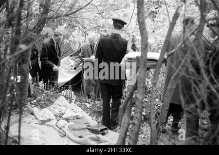 Harry Roberts wollte im Zusammenhang mit der Erschießung von drei Londoner Polizisten wurde heute in einem Wald bei Bishops Stortford in Herts wieder aufgenommen. Roberts, der seit mehr als drei Monaten gesucht wird, gab ohne Probleme der Polizei sgt Peter Smith nach. In einem getarnten Zelt am Rande von Thorley Wood entdeckte die Polizei eines der geschickt ausgeklügeltesten Verstecke, die je bekannt waren, wo Roberts in den letzten sechs Wochen gelebt hat. Das Zelt ist 5ft hoch an seinem höchsten Punkt und von einer Plastikfolie getarnt und enthielt eine Fülle von Lebensmitteln und Brennstoffen. Ein Camp-Bett und ein Aluminium-Stuhl wie wir Stockfoto