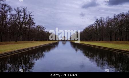 Schönes langes Seewasser mit Bäumen in der Nähe des Schlosses Nymphenburg in München Stockfoto