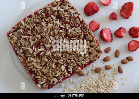 Die Frühstücksbar war frisch aus dem Ofen und wurde aus Schimmel geholt. Es gab kein Mehl-Frühstücksbar mit Haferflocken, Mandeln, Frischkäse und frischen Erdbeeren. Schuss auf Whit Stockfoto