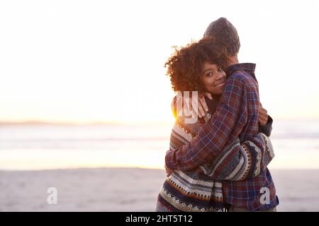 Das ist, wo ich hingehöre. Aufnahme eines jungen Paares, das einen Spaziergang am Strand genießt. Stockfoto