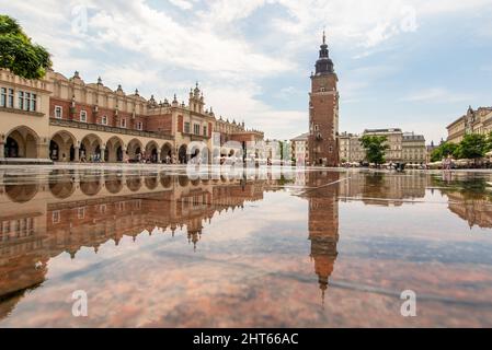 Häufige Regenschauer lassen die Altstadt von Krakau wie einen Spiegel aussehen, wenn es voll nass ist. Hier insbesondere Market Square, ein Wahrzeichen Stockfoto