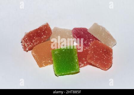 Nahaufnahme von farbenfrohen Gelee-Bonbons, die mit Zucker bedeckt sind und auf weißem Hintergrund isoliert sind Stockfoto