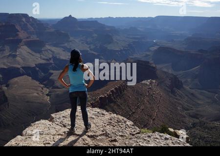 Ein Mädchen blickt auf die Klippen, Felswände und Felsschichten hinunter in die Tiefen des Grand Canyons am Shoshone Point am Südrand. Shoshone Point Stockfoto