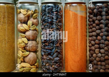 Verschiedene Gewürze aus der Nähe in Glaskolben für Gewürze. Stockfoto