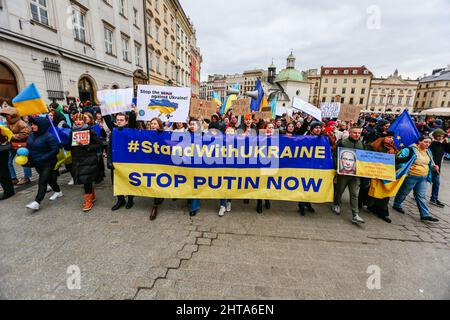 Mitglieder der ukrainischen Gemeinschaft sahen während der Demonstration mit einem Transparent marschieren, auf dem stand: "Steht mit der Ukraine - stoppt Putin jetzt". Ein Antikriegsprotest der ukrainischen Gemeinschaft, der Polen und der Belarussen, die sie unterstützen. Seit Beginn der russischen Invasion in der Ukraine fanden täglich und viele Stunden lang Demonstrationen statt. Die Teilnehmer versuchen ständig, möglichst viele Menschen mit ihrer Botschaft zu erreichen, darunter auch Mitarbeiter der US- und deutschen Konsulate, vor denen sie auch mehrmals täglich Halt machen. Stockfoto