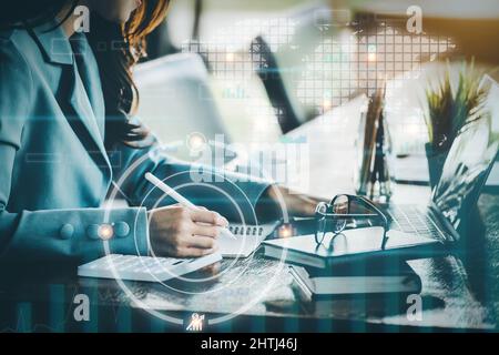 Finanzplanungs- und Kontrollkonzepte, Frauen halten Stift mit Notebook, um Anlageabrechnungen zu berechnen, während sie Tablet-Computer zur Arbeit nutzen Stockfoto