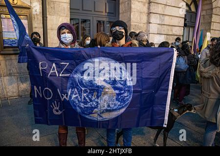 Burgos, Spanien. 27.. Februar 2022. Die Demonstranten halten während der Demonstration eine Erdflagge mit der Aufschrift "Frieden, kein Krieg".Eine große Anzahl ukrainischer Demonstranten konzentrierte sich in der Stadt Burgos, um das Ende des Krieges in der Ukraine zu fordern. (Bild: © Jorge Contreras/SOPA Images via ZUMA Press Wire) Stockfoto