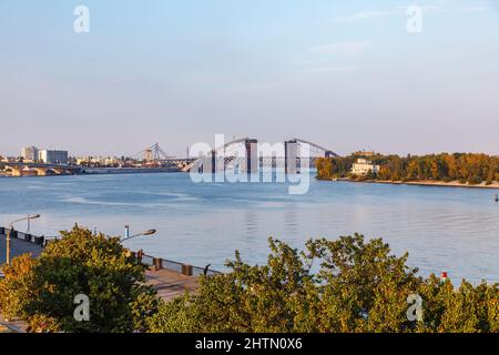 Die Podilskyi-Brücke, eine Straßen- und Eisenbahnbrücke, die den Dnjepr-Fluss von Podil bis zu den Woskresenka-Bezirken, Kiew (Kiew), Ukraine, überspannt, befindet sich im Bau Stockfoto