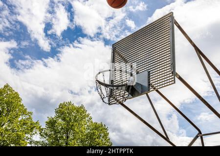 Verwitterter Basketballkorb an einem sonnigen Tag im Sommer Stockfoto