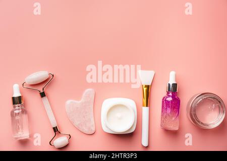 Jade Gesichtswalzen und Gua Sha Steine für die Schönheits-Gesichtsmassagetherapie, Artikel für die Behandlung zu Hause mit Hautpflege Anti-Aging-Tools, Gesichts-Serum und feucht Stockfoto