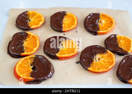 In Schokolade getauchte kandierte Orangenscheiben. Stockfoto