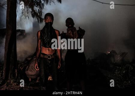 Nairobi, Kenia. 1. März 2022. Jungen nehmen während eines Brandausbruchs in den Slums von Kibera in Nairobi eine Haltung ein. Am 1.. März 2022. Die Bewohner der Slums von Kibera erlebten einen weiteren Verlust, als sie von einem Feuer, das spät in der Nacht auftrat und zwanzig Häuser niederwüste, nicht bemerkt wurden, und die meisten Einheimischen obdachlos blieben und sich an nichts wenden konnten. Der Ausbruch des Feuers war auf verworrene Drähte aus illegalen elektrischen Verbindungen zurückzuführen. (Bild: © Donwilson Odhiambo/ZUMA Press Wire) Stockfoto