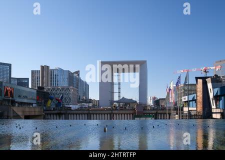 Paris, Frankreich - 27. Februar 2022 : Ein Wasserbecken im berühmten Geschäftsviertel La Défense und der große Verteidigungsbogen im Hintergrund Stockfoto