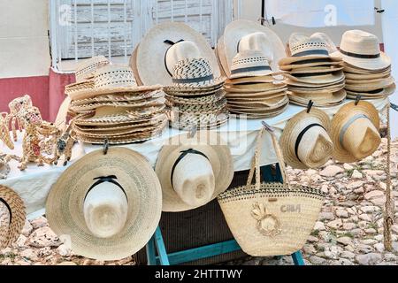 Souvenirs für Touristen: Strohhüte, Taschen, handgemachtes Spielzeug auf dem Straßenmarkt in Trinidad, Kuba. Stockfoto