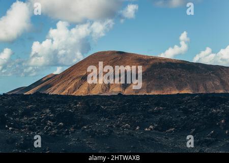 Atemberaubende Panoramalandschaft mit Vulkankrater im Timanfaya-Nationalpark. Beliebte Touristenattraktion auf der Insel Lanzarote, Kanarische Inseln, Spanien Stockfoto