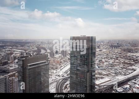 Städtische Gebiete und Autobahnen sind mit Schnee bedeckt. Alltag der Stadt, Draufsicht auf Moskau an einem Wintertag, Luftaufnahmen Stockfoto