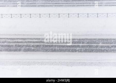 Schneefall auf der leeren Autobahn, schlechte Sicht Stockfoto