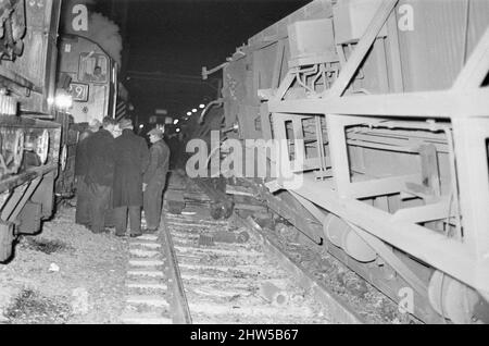 Der Eisenbahnunfall von Stechford 1967 ereignete sich am 28.. Februar 1967 am Bahnhof Stechford in der Gegend von Stechford in Birmingham, England. Hauptursache - Treiberfehler. Sekundäre Ursache - Shunter-Fehler. Ergebnis Nebeneinanderprall, Entgleisung, Kollision mit der Struktur. 9 Tote, 16 Verletzte. Unser Bild Zeigt ... Notdienste, die die ganze Nacht über arbeiten. Eine Diesellokomotive der Baureihe 24 war mit einem Ballastzug am Stechford-Nebengleise angekommen. Dies sollte nach Nuneaton zurückkehren und so musste die Lokomotive um den Zug fahren. Es gab zu viele Waggons für die Rundlaufschleife, um uns zu sein Stockfoto