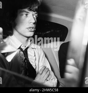 Mick Jagger von der Popgruppe der Rolling Stones verlässt Wormwood Scrubs, nachdem er mit seinem Rechtsberater angekommen war, um nach seiner eigenen Freilassung aus dem Brixton Gefängnis den Bandkollegen Keith Richards zu sammeln. 30.. Juni 1967. Stockfoto