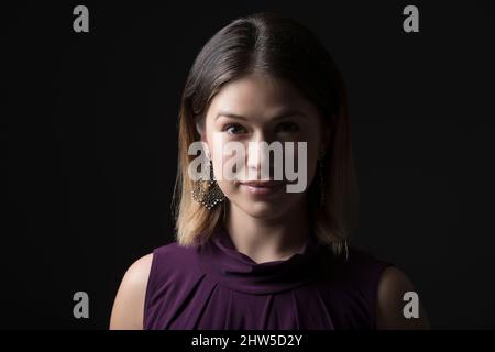 Studio-Porträt einer Frau im ärmellosen lila Oberteil Stockfoto