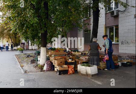 Eine ukrainische Frau, die an einer Straßenecke in Kiew, Ukraine, Obst verkauft. Stockfoto